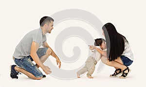 Portrait of a happy family that teaches a child to walk