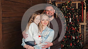 Portrait of Happy Family of three people on Christmas Eve at Home.