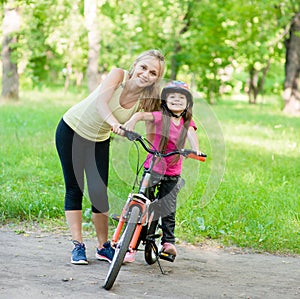 Portrait of a happy family, to ride a bike in the park