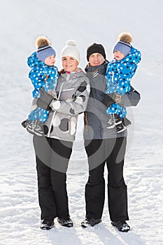 Portrait of happy family with twins in winter Park on a Sunny day