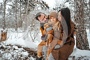 Portrait of happy family in winter clothes in forest