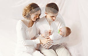 Portrait of happy family, young parents with baby at home