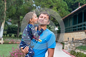Portrait of a happy father with his little son on vacation. Little boy kisses and hugs his father. Happy fathers day.Happy family.