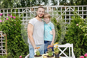 Portrait of happy father and son standing in yard