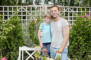 Portrait of happy father and son standing in yard