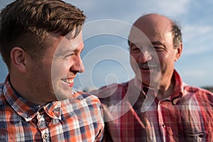 Portrait of happy father and son walking outdoors.