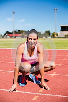 Portrait of happy female athlete warming up