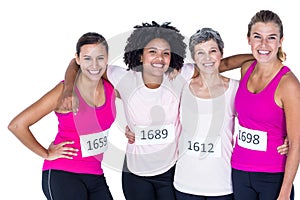 Portrait of happy female athletes with arms around