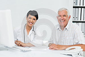 Portrait of a happy female doctor with male patient