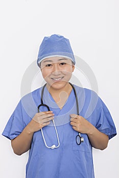 Portrait of happy female doctor with stethoscope around neck against white background