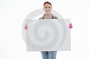 Portrait of happy female doing house duties wearing rubber gloves and holding cleaning equipment. Cheerful look. Hygiene, cleaning