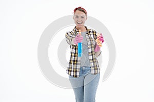 Portrait of happy female doing house duties wearing rubber gloves and holding cleaning equipment. Cheerful look. Hygiene, cleaning