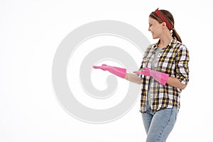 Portrait of happy female doing house duties wearing rubber gloves and holding cleaning equipment. Cheerful look. Hygiene, cleaning