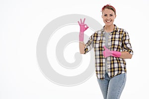 Portrait of happy female doing house duties wearing rubber gloves and holding cleaning equipment. Cheerful look. Hygiene, cleaning