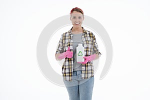 Portrait of happy female doing house duties wearing rubber gloves and holding cleaning equipment. Cheerful look. Hygiene, cleaning