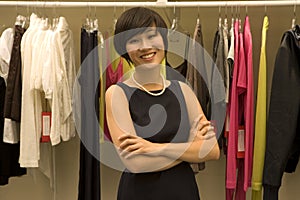 Portrait of happy Female fashion designer standing arms crossed