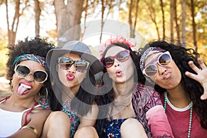 Portrait of happy female friends making faces at campsite