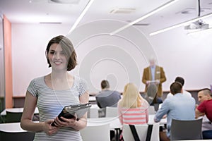 Portrait of happy female student in classroom