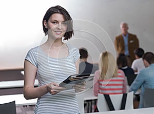 Portrait of happy female student in classroom