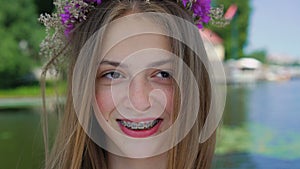 Portrait of happy female teen with braces on teeth smiling at camera. 4K