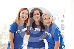 Portrait of happy female volunteers in uniform photo