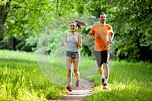 Portrait of happy fit people running together ourdoors. Couple sport healthy lifetsyle concept