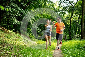 Portrait of happy fit people running together ourdoors. Couple sport healthy lifetsyle concept