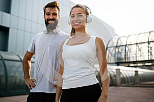 Portrait of happy fit sporty couple exercising and enjoying healthy lifestyle. People sport concept