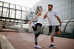 Portrait of happy fit sporty couple exercising and enjoying healthy lifestyle. People sport concept