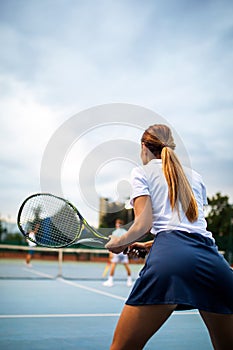 Portrait of happy fit young woman playing tennis. People sport healthy lifestyle concept