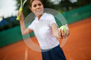 Portrait of happy fit young woman playing tennis. People sport healthy lifestyle concept