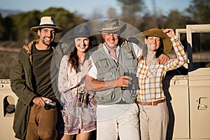 Portrait of happy friends enjoying during safari vacation