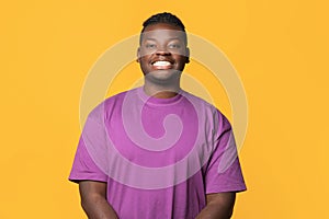 Portrait Of Happy Funny African American Man On Yellow Backdrop