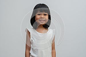 Portrait of happy and funny Asian child girl on white background, a child looking at camera. Preschool kid dreaming fill with