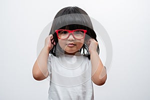 Portrait of happy and funny Asian child girl on white background, a child looking at camera hand gesture. Preschool kid dreaming