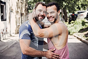 A Portrait of a happy gay couple outdoors in urban background