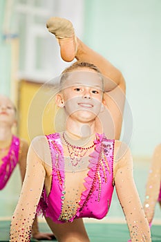 Portrait of happy girl doing rhythmic gymnastics