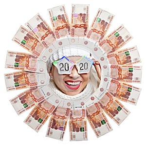 Portrait of a happy girl in glasses with the inscription 2020 in the center of the circle of Russian money.