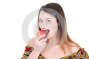 Portrait of happy girl holding eating red apple