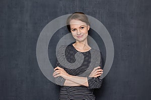 Portrait of happy girl holding hands crossed on chest