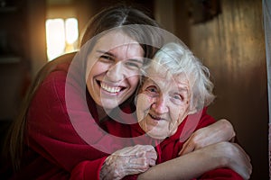 Portrait of happy Girl hugging her grandmother.