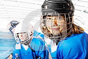 Portrait of happy girl in ice hockey uniform