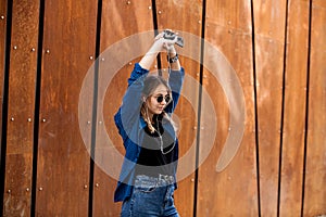 Portrait of a happy girl listening music on line with headphones from a smartphone in the street in a summer sunny day. Woman list