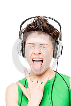 Portrait of happy girl loves hard rock with headphones