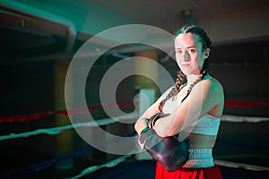 Portrait of happy girl posing on boxing ring