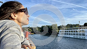 portrait of a happy girl in sunglasses taking a boat ride on the river