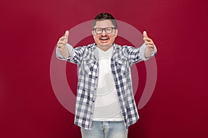 Portrait of happy glad to seeing handsome middle aged business man in casual checkered shirt and eyeglasses standing toothy smile