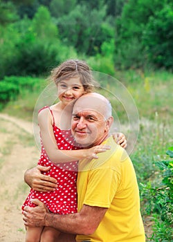 Portrait of  granddad and grandaughter playing at the park photo