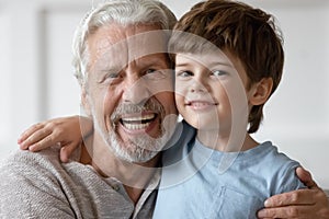 Portrait of happy grandfather hug little grandson