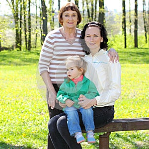 Portrait of happy grandmother, daughter and granddaughter outdoors